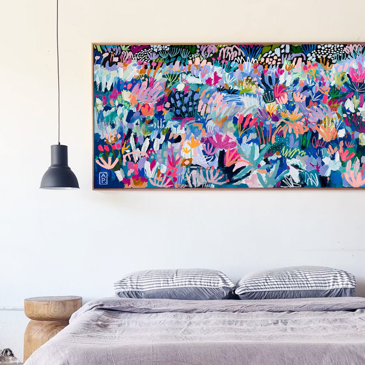 Bedroom with a colorful abstract painting above the bed