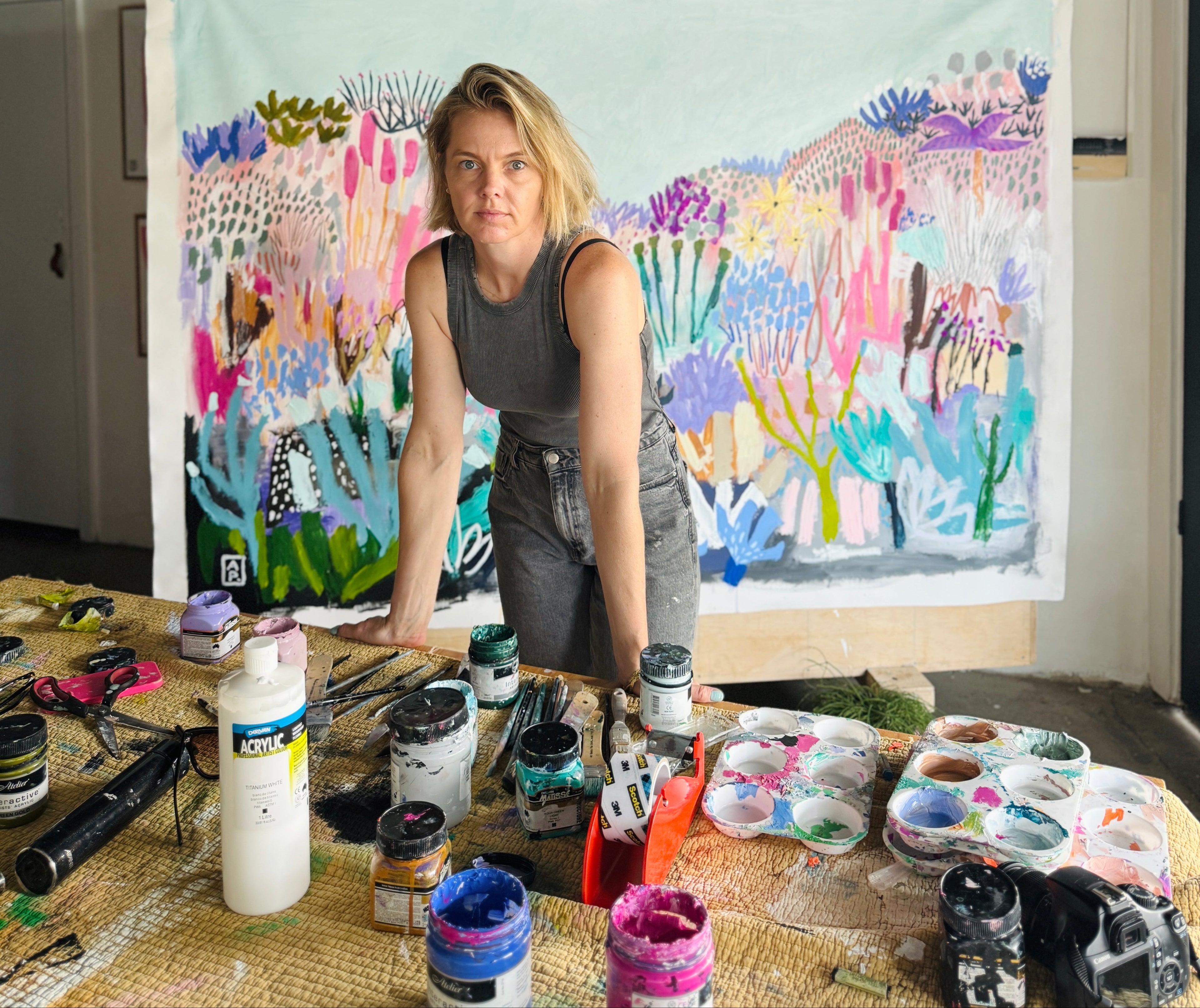 Artist working on a colorful painting in an studio