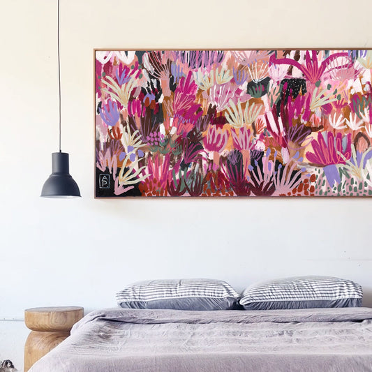 Bedroom with a colorful abstract painting above the bed