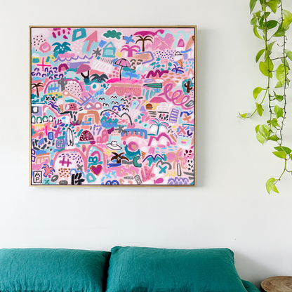 Colorful abstract art print on a white wall above a bed with teal bedding.