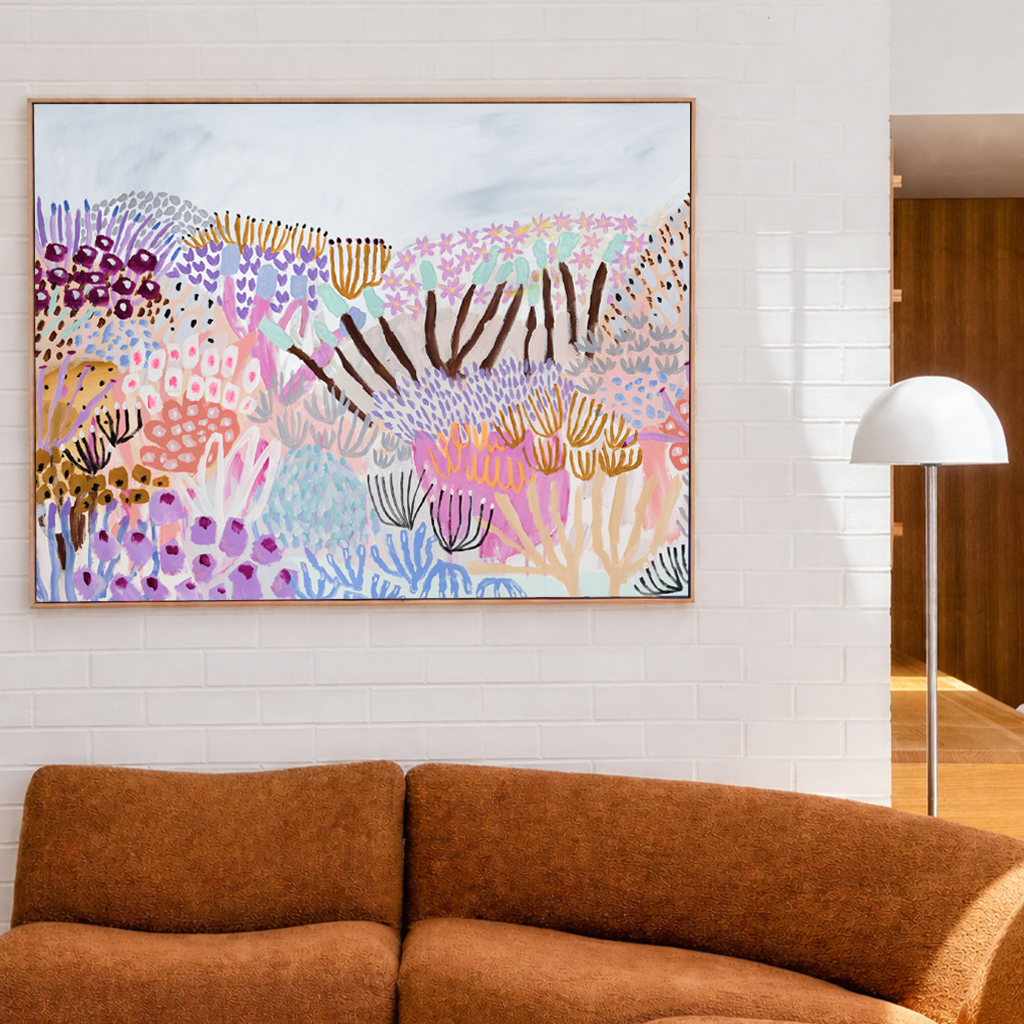Brown sectional sofa in a living room with a colorful abstract painting on the wall.